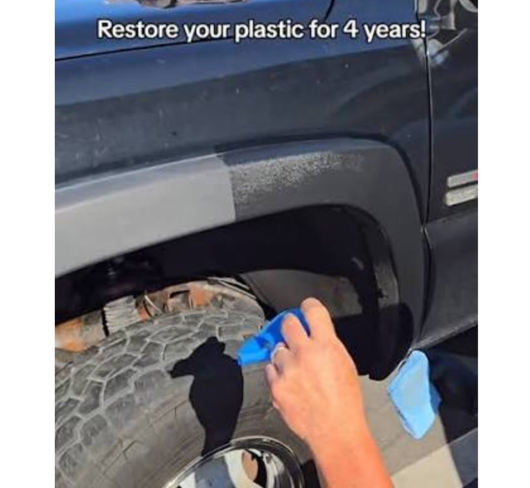 Truck fender flare mid-restoration — faded gray plastic on one side, restored deep black finish on the other
